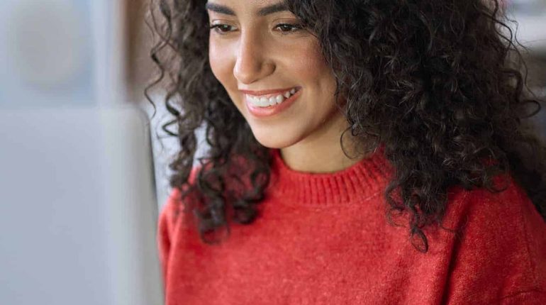 young-happy-latin-woman-student-elearning-using-laptop-vertical-shot.jpg